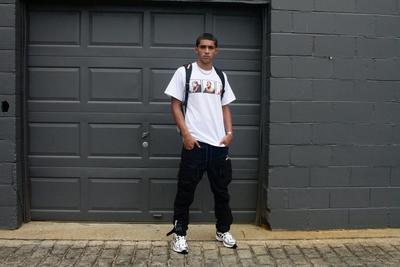 Boy in jeans, Sprayground backpack, and New Balance 1906