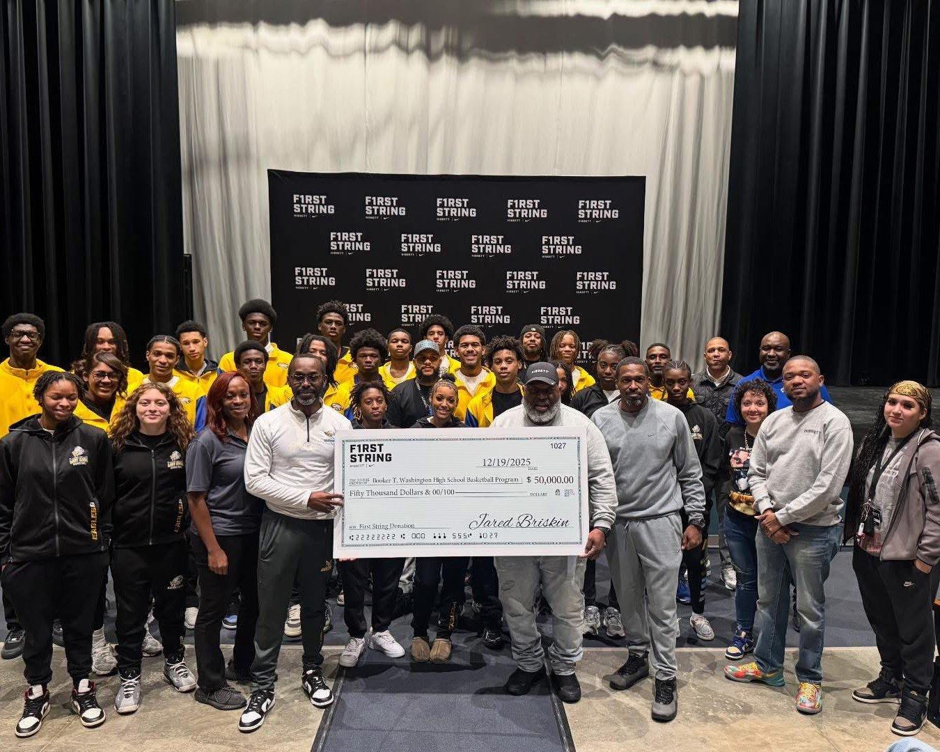 Group of people with large check