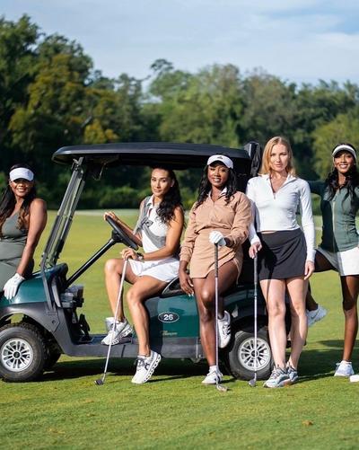 Keyeriah Miles and group t golf course on golf cart