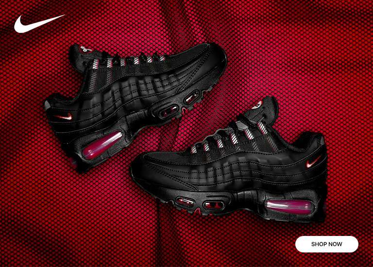 A banner image showcasing a pair of kids' Nike Air Max 95 sneakers in a black and deep red/magenta colorway. The shoes are resting on a red mesh and fabric background. The Nike Swoosh is visible in the top left corner, and a Shop Now button is in the bottom right.