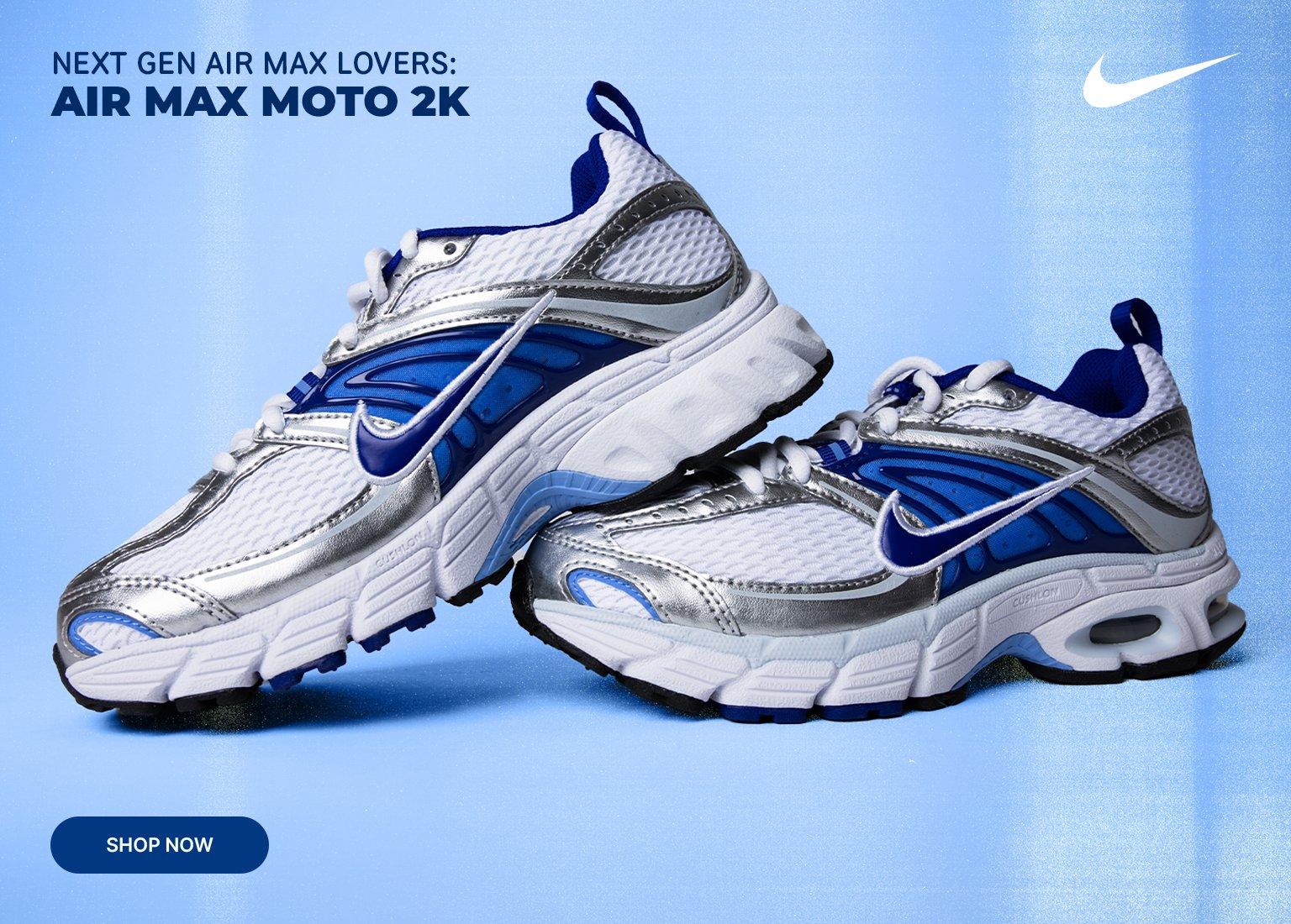 Marketing banner for Nike Air Max Moto 2K shoes. The image shows a pair of white, silver, and blue sneakers against a light blue background. Text in the corner reads "Next Gen Air Max Lovers: Air Max Moto 2K" with a "Shop Now" button below.