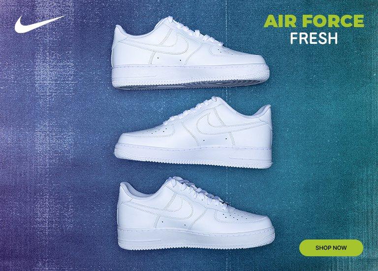 A wide promotional banner featuring two white Nike Air Force 1 sneakers stacked vertically on the right side against a textured blue and teal gradient background. On the left, a white Nike swoosh sits above the text 'AIR FORCE' in lime green and 'FRESH' in white. A lime green 'SHOP NOW' button is positioned below the text.