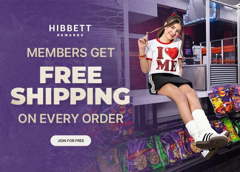 An advertisement for Hibbett Rewards features a young girl sitting on a counter in a convenience store setting, surrounded by snacks. She is wearing a white T-shirt with a red heart graphic that says I HEART ME, a black skirt, and white sneakers with tall socks. The left side of the image has a purple textured overlay with the Hibbett Rewards logo and large bold text stating MEMBERS GET FREE SHIPPING ON EVERY ORDER. A white button at the bottom reads JOIN FOR FREE.