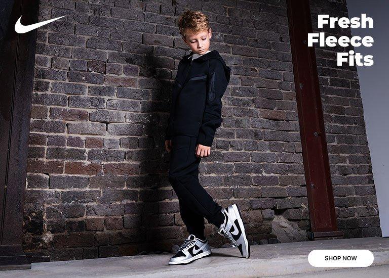 Kids' Nike tech fleece outfit with black-and-white Nike Dunk sneakers.