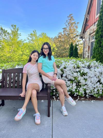 Jules and Yuni Mon sitting on a bench
