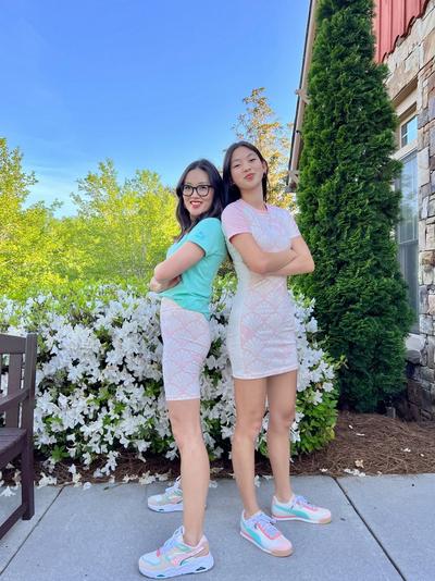 Jules and Yuni Min posing back to back