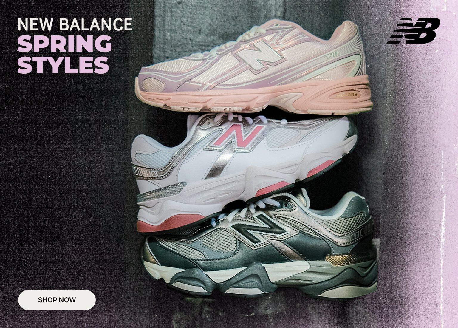 Three New Balance sneakers in pink, white/pink, and green/metallic colorways are stacked vertically against a dark, textured background. The top left corner features the text NEW BALANCE SPRING STYLES, a black NB logo is in the top right, and a white SHOP NOW button sits in the bottom right corner.