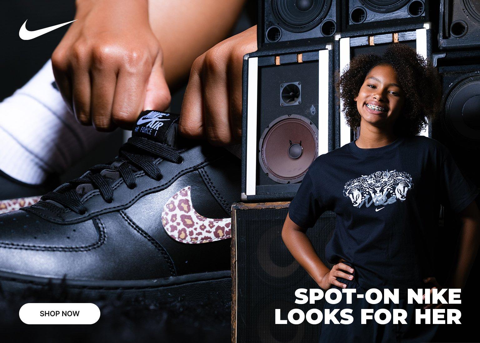 Promotional image featuring a close-up of a black Nike Air Force 1 sneaker with a cheetah-print swoosh and a young girl standing next to speakers. The text reads SPOT-ON NIKE LOOKS FOR HER and includes a SHOP NOW button.