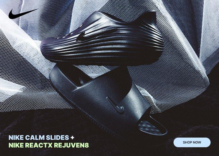 A promotional banner featuring the black Nike ReactX Rejuven8 mule stacked on top of a black Nike Calm Slide. The footwear is set against a dark, textured background with draped mesh fabric. Text on the right reads NIKE CALM SLIDES + NIKE REACTX REJUVEN8 with a Shop Now button below.
