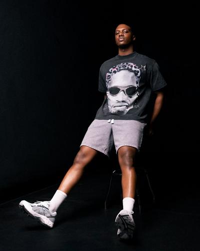 Young man in Asics 2160, Reason Fleece Shorts, and ID CO Iced Rodman Tee 