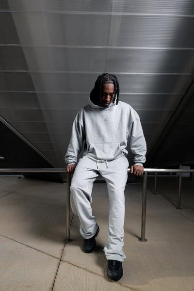 Man in Nike grey sweat pants and hoodie