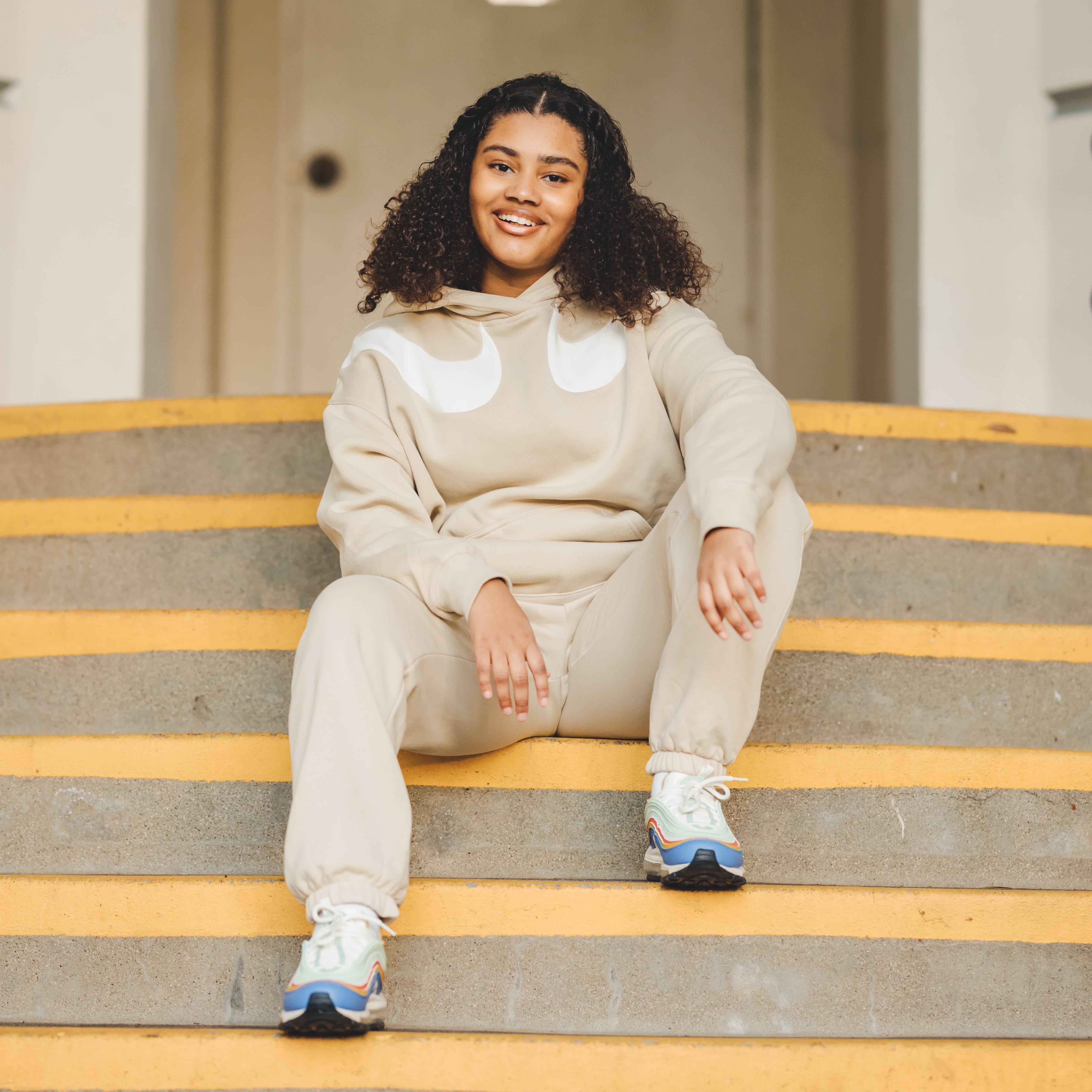 Haileigh Vasquez posing for Support Her Sole episode in Nike fleece jogging suit