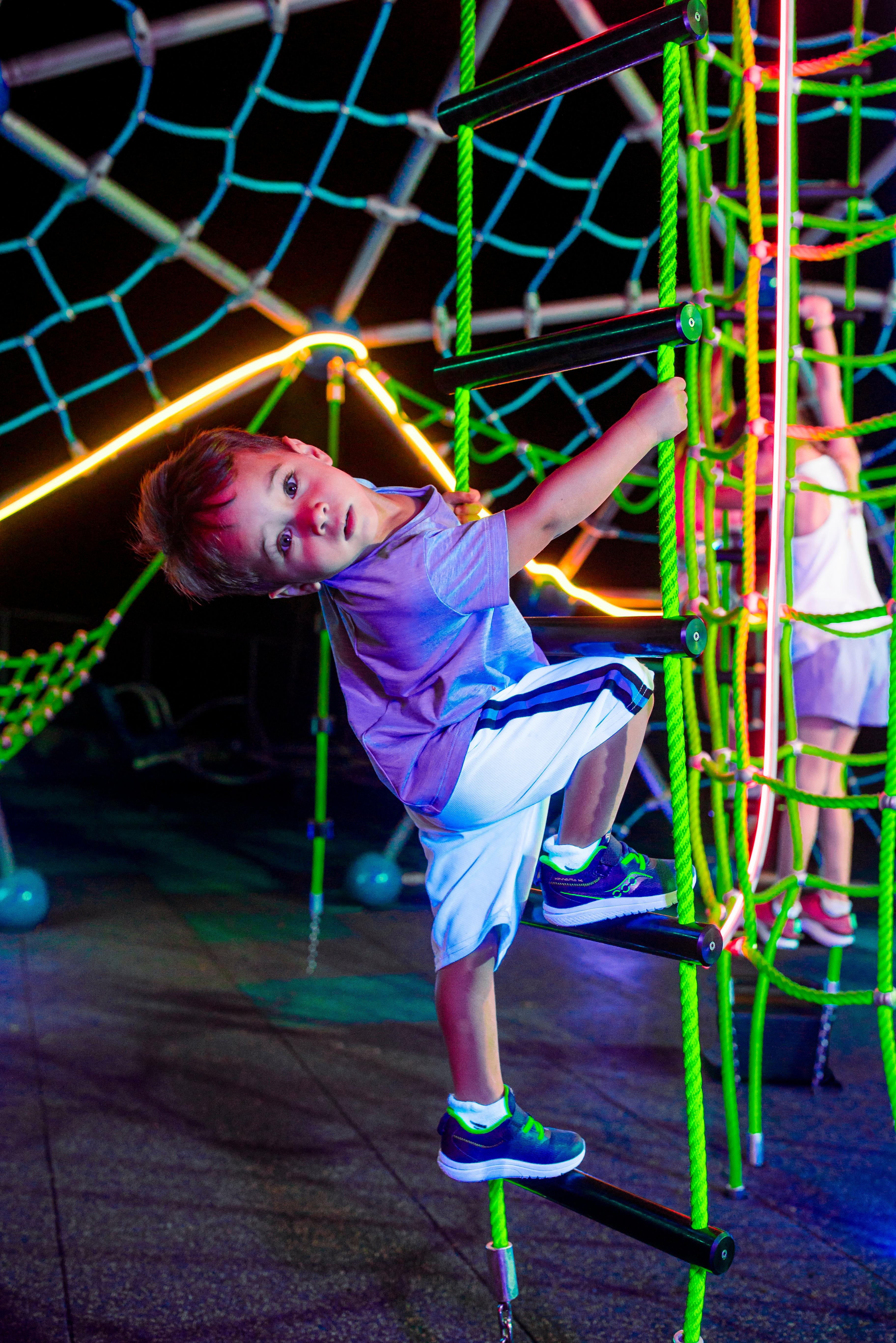 Kids' Saucony running shoe on playground jungle gym