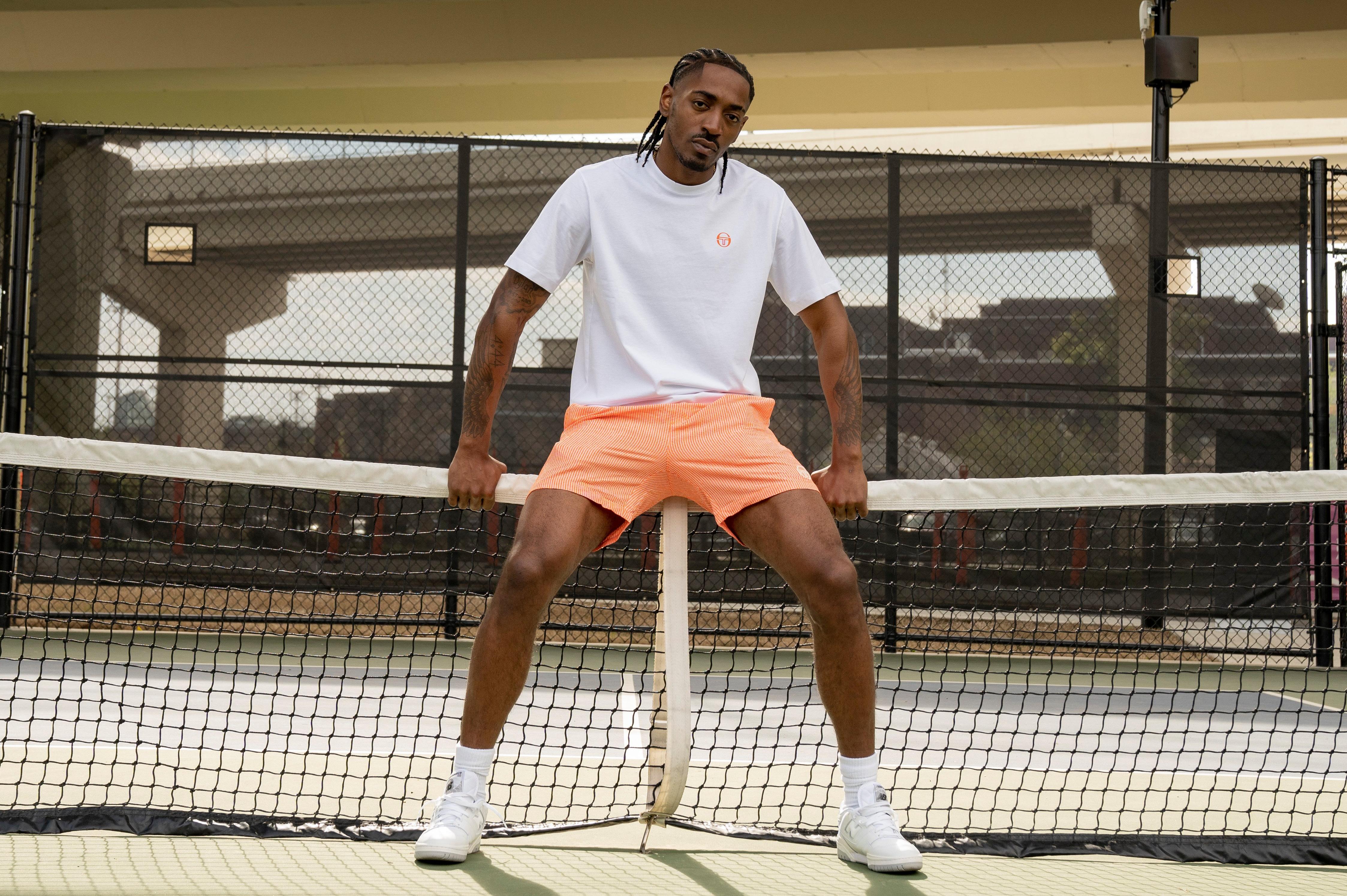 Sergio Tacchini orange and white tee and nylon track shorts. 