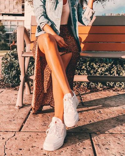 Young man in red, black, and outfit, with red and black Nike Air Force 1s