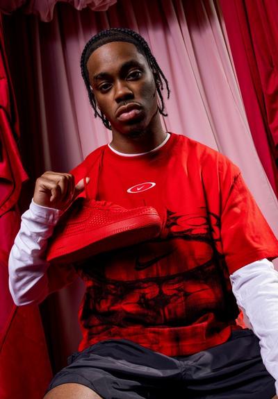 Young man with red Air Force 1s around his neck