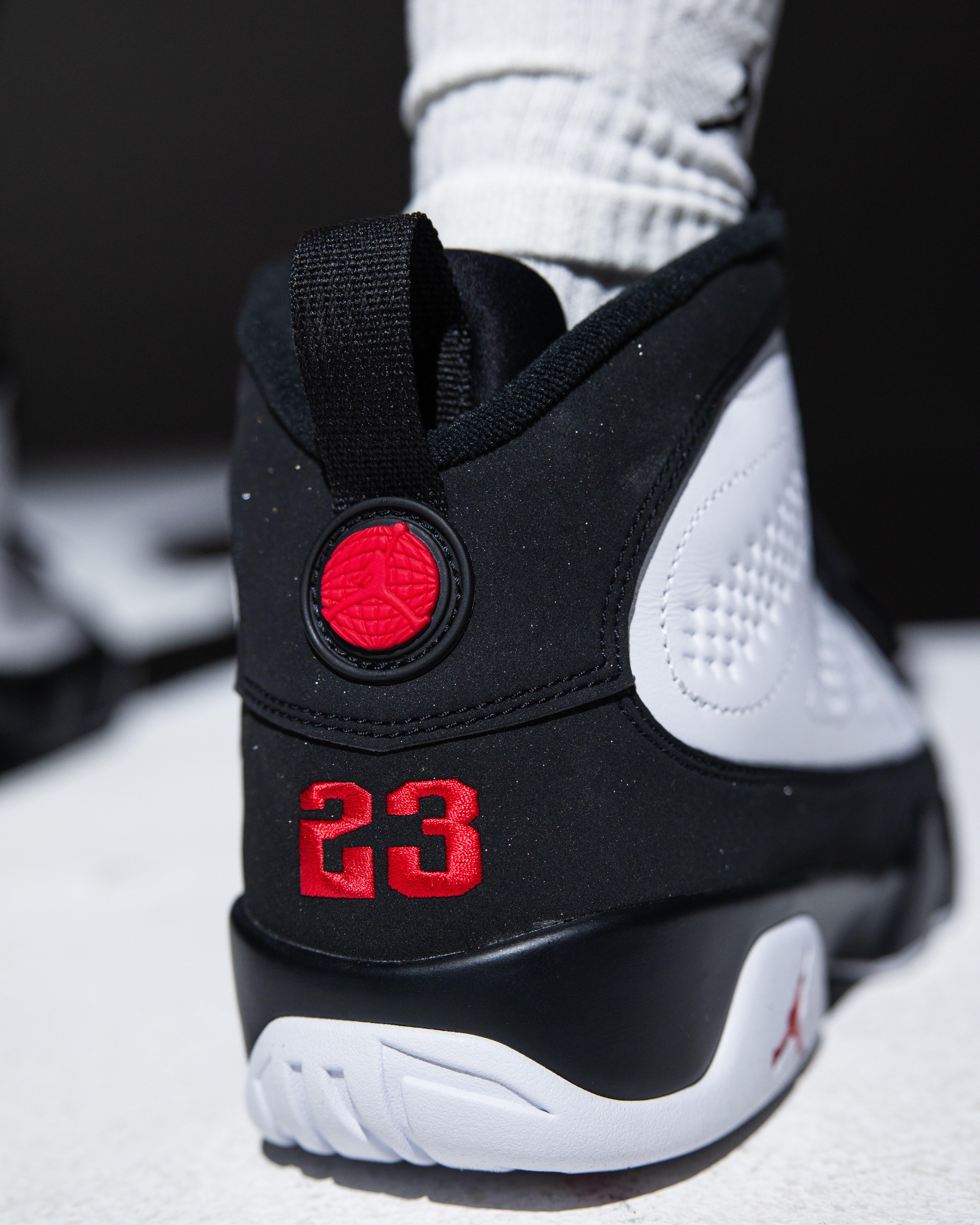 Close-up of the Air Jordan 9 Retro Space Jam heel featuring a black pull tab, red globe emblem and embroidered number 23.