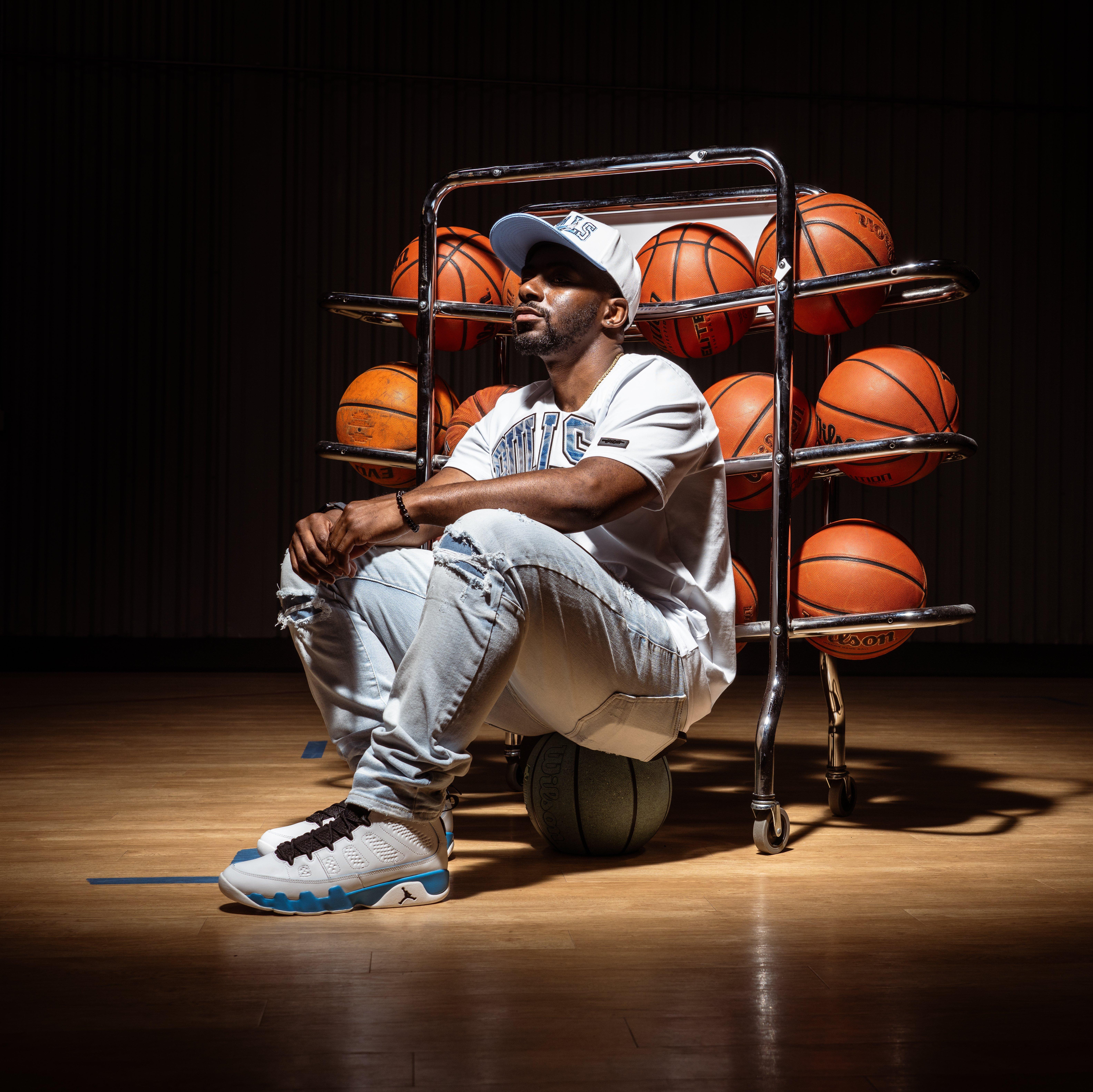 Air Jordan 9 Retro OG "Powder Blue" - Model Wearing Them Near Ball Rack