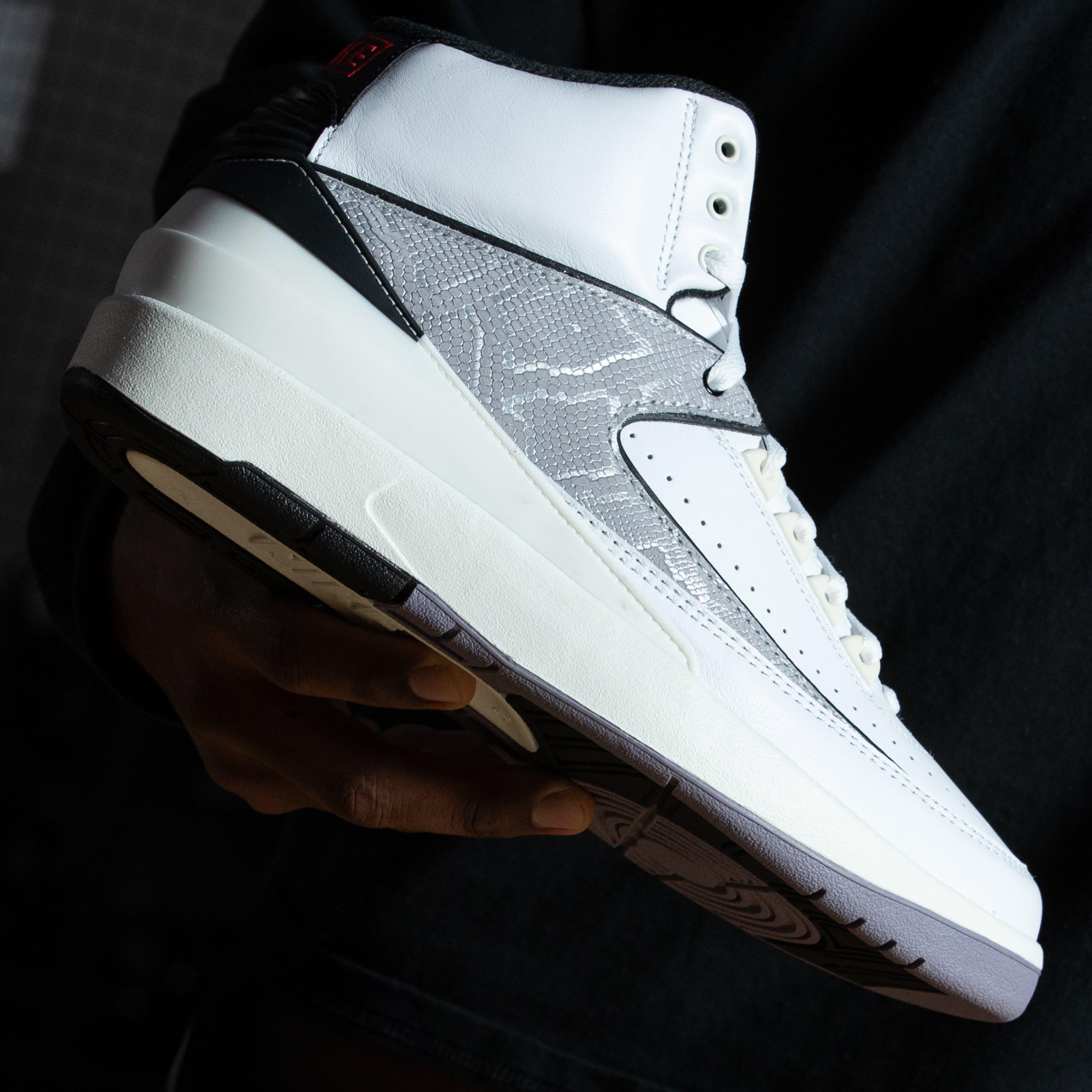 Air Jordan 2 Retro "Python" Held In Air with Black Background