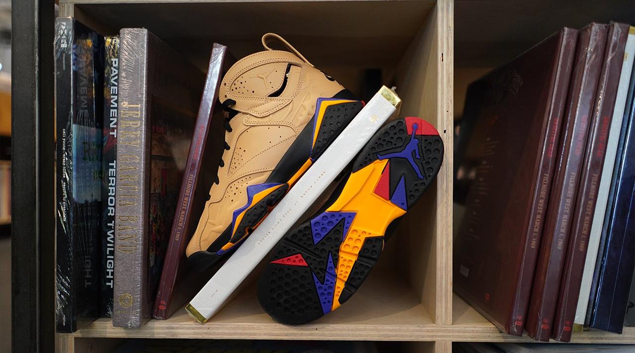 Jordan 7 Retro SE "Vachetta Tan/Black/Taxi" stacked on records