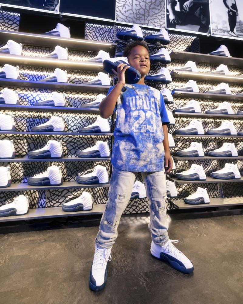 Boy modeling Jordan 12 Retro &ldquo;French Blue and White&rdquo;