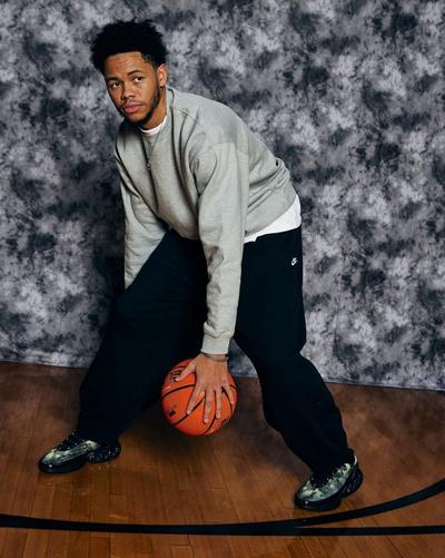 Anfernee Simons on photoshoot set dribbling ball under his legs