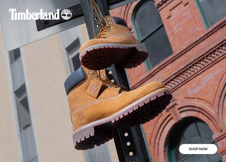 Timberland wheat boots in kids' sizes displayed in an urban setting.