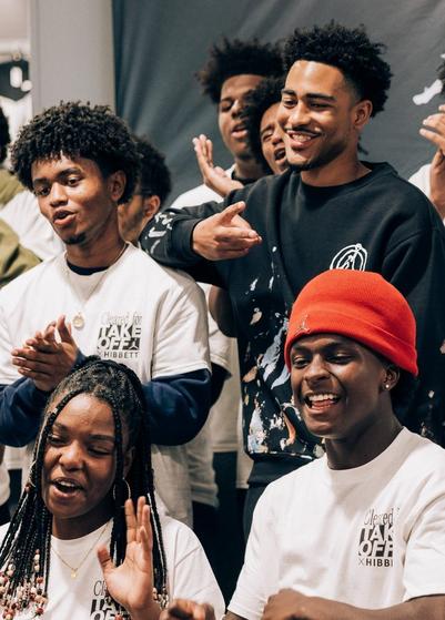 Bryce Young posing with youth in Hibbett in-store moment