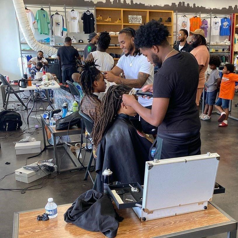 Row of barbers with clients at Dayton, OH Cutz for Kids event