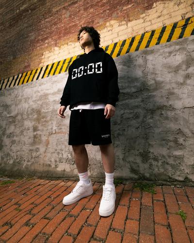 Tommy Nguyen in black hoodie and shorts