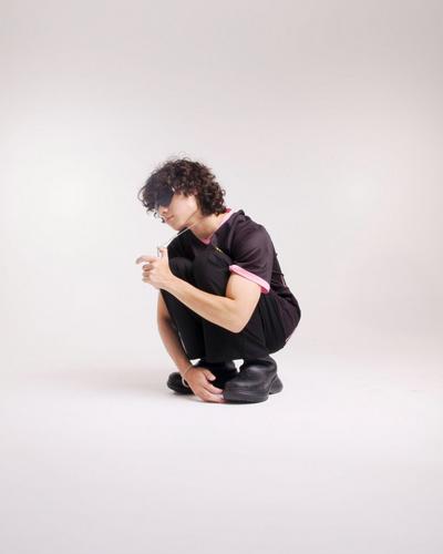Tommy Nguyen in black outfit