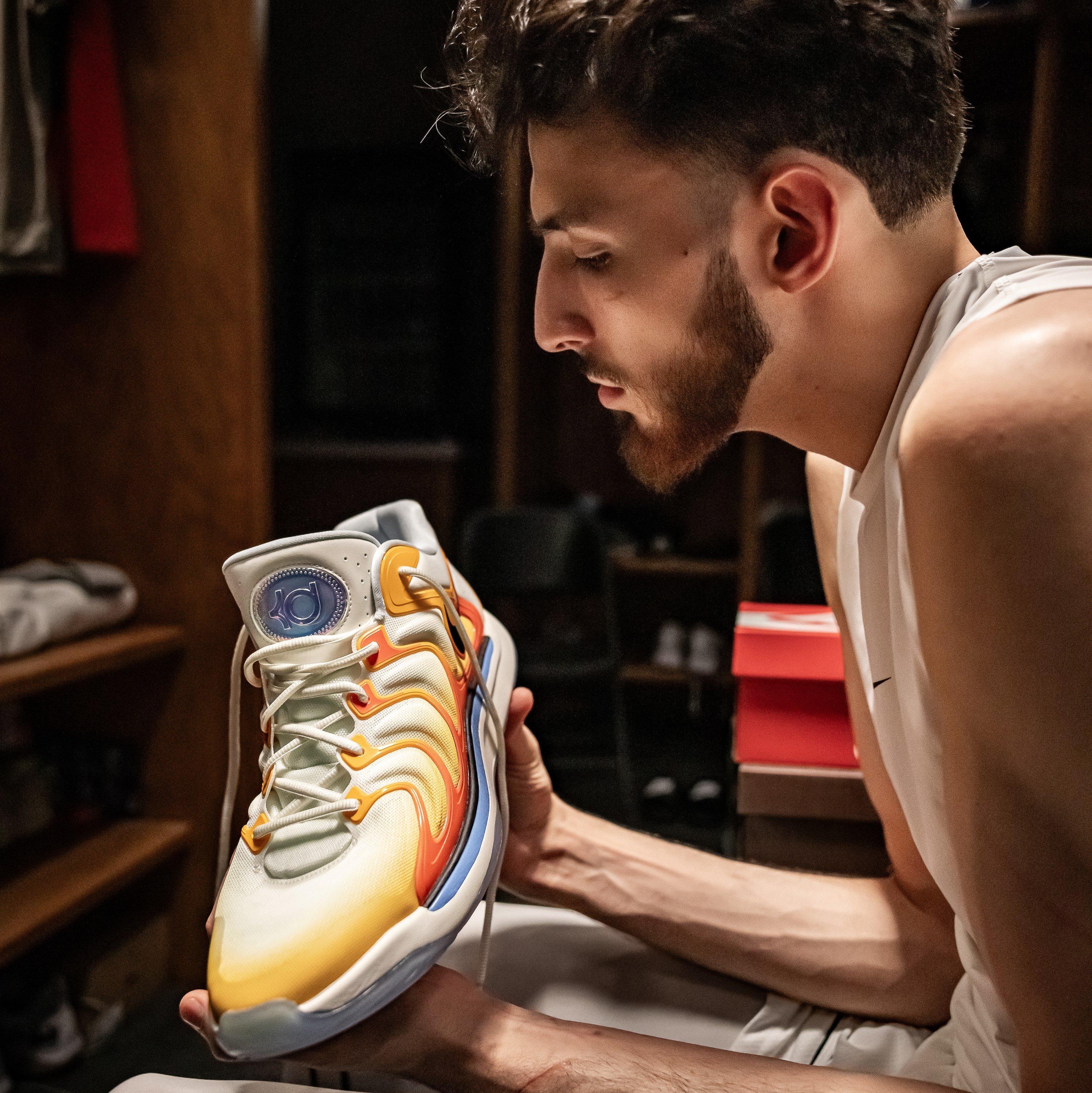 chet-holmgren-holding-nike-kd17-yellow-orange-colorway