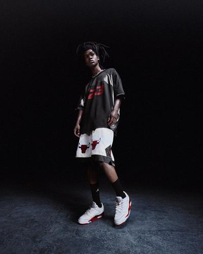 Young man in Chicago Bulls basketball shorts, shirt, and Jordan sneakers