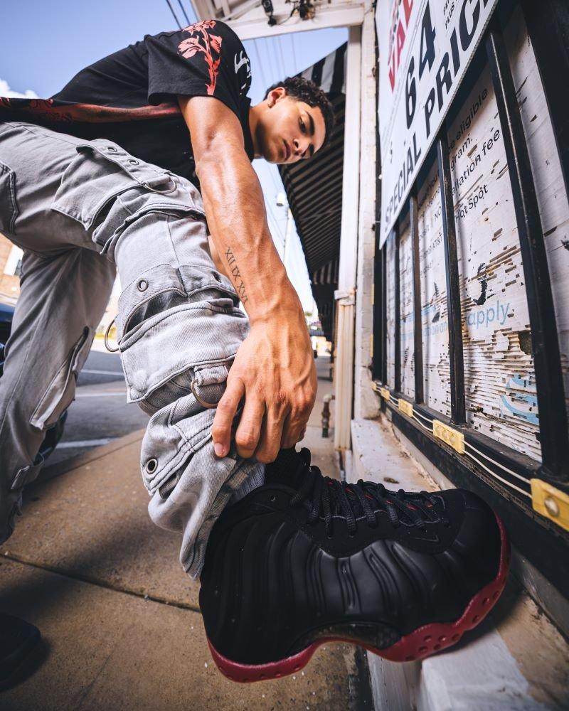 Man modeling Nike Air Foamposite One "Cough Drop"