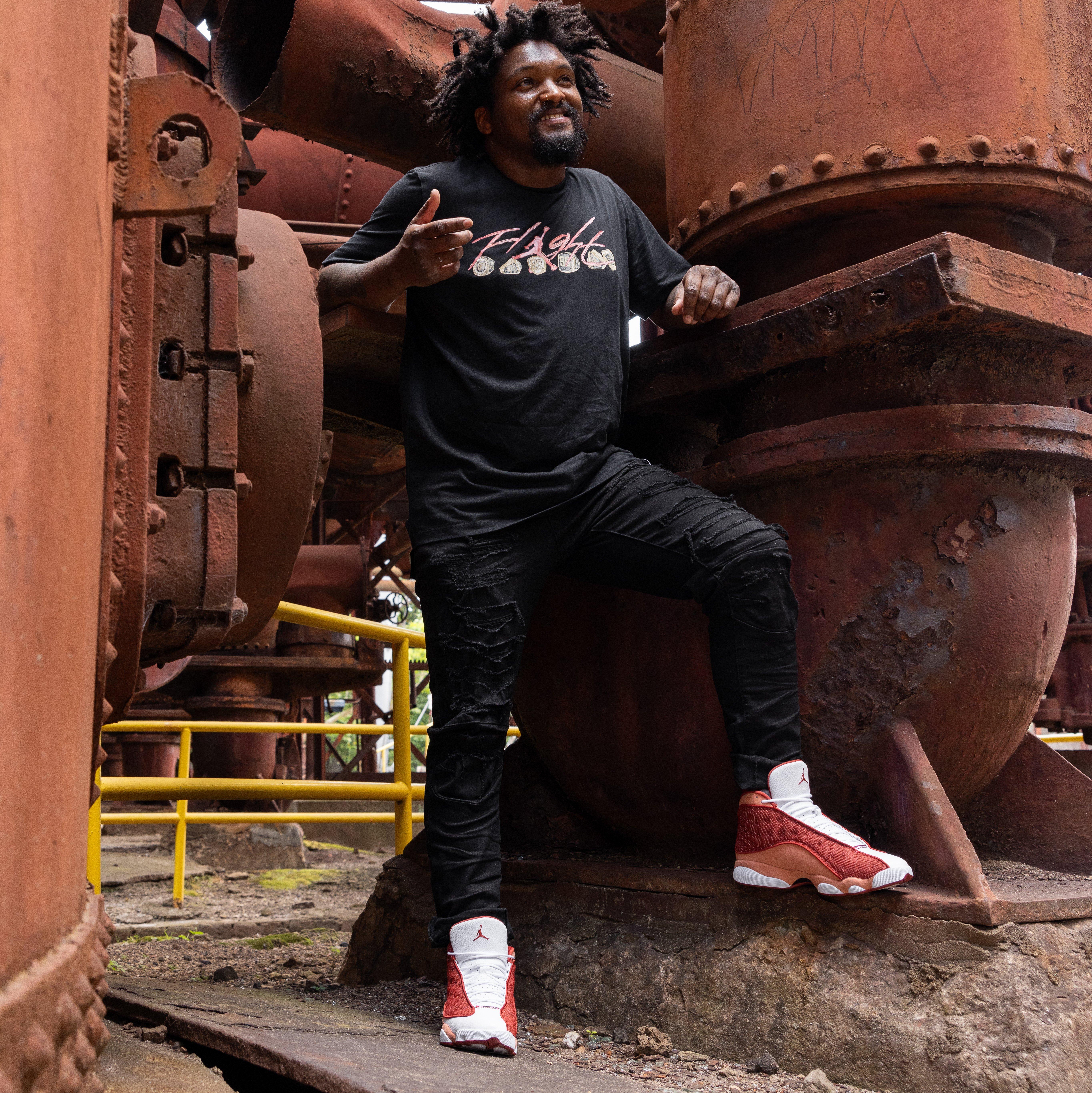 Air Jordan 13 Retro "Dune Red" Left Shoe Inner Side - Model Posing at Sloss Furnace 