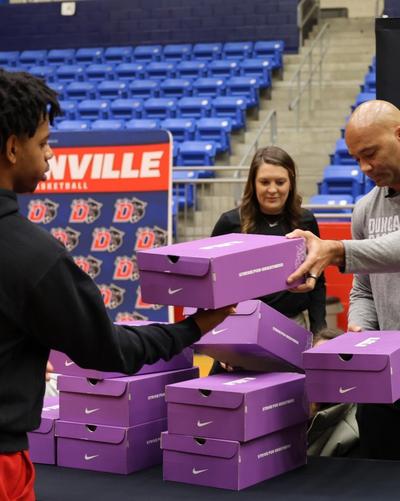 https://cdn.media.amplience.net/i/hibbett/duncanville-hs-mens-basketball-player-receiving-new-shoes