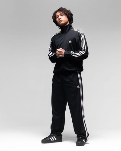 Man modeling adidas Firebird Tracksuits pants