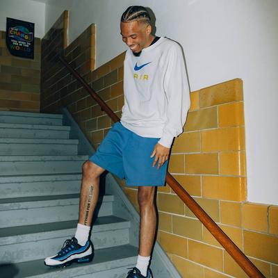 Drew Brown - The Film Lord - standing on stairs in Nike Sweatshirt, shorts and Air Max 95s