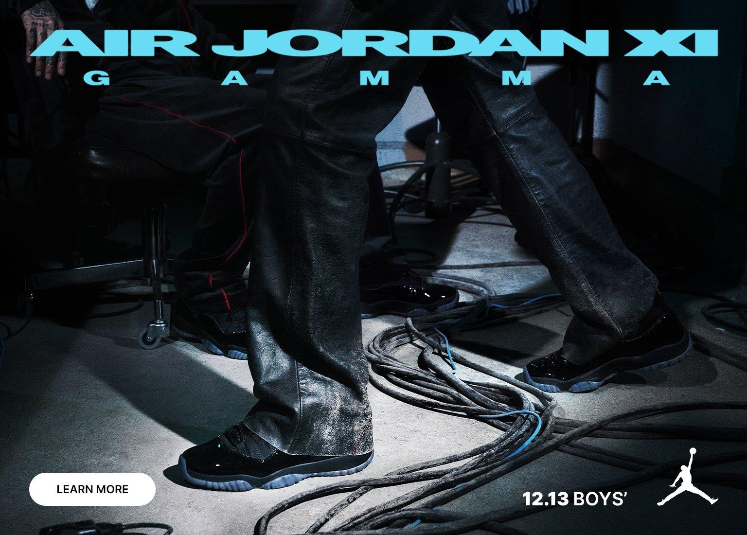 Advertisement for the black and blue Air Jordan XI "Gamma" sneakers, showing a person wearing them with black leather pants amidst wires. The text "AIR JORDAN XI GAMMA" and "12.13 BOYS'" is visible.