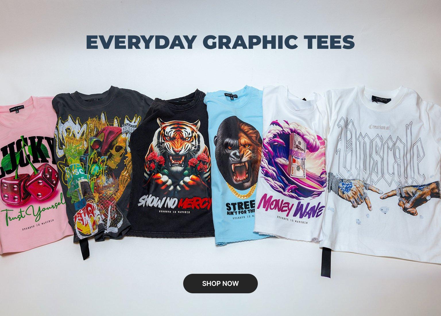 A promotional banner titled EVERYDAY GRAPHIC TEES showing six folded streetwear t-shirts in various colors including pink, charcoal, black, light blue, and white. The shirts feature bold graphics like a tiger, a Money Wave surfing stack of cash, and a jewelry-heavy parody of the Creation of Adam. A SHOP NOW button is at the bottom.