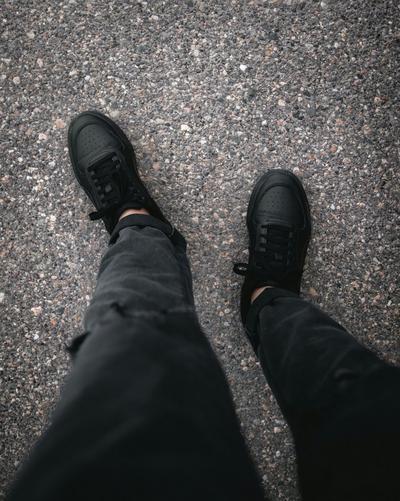 Pair of Black Air Force 1s styled with black jeans