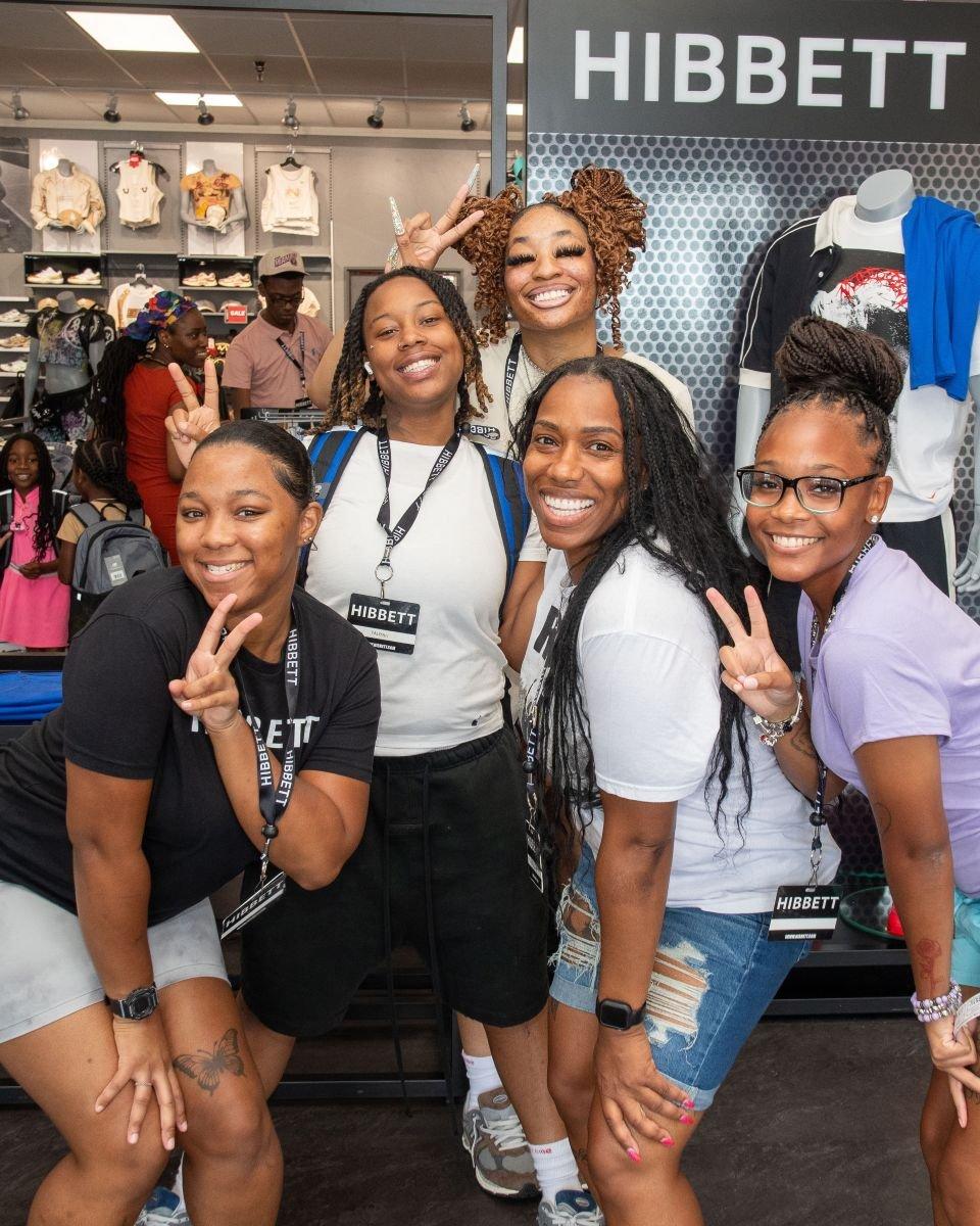 Group photo of Hibbett team members and participants inside a Hibbett store.