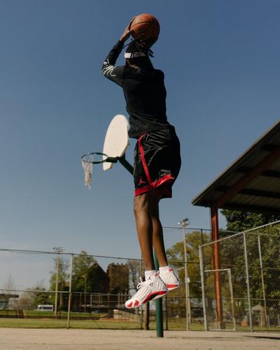 man in Jordan Retros shooting basketball