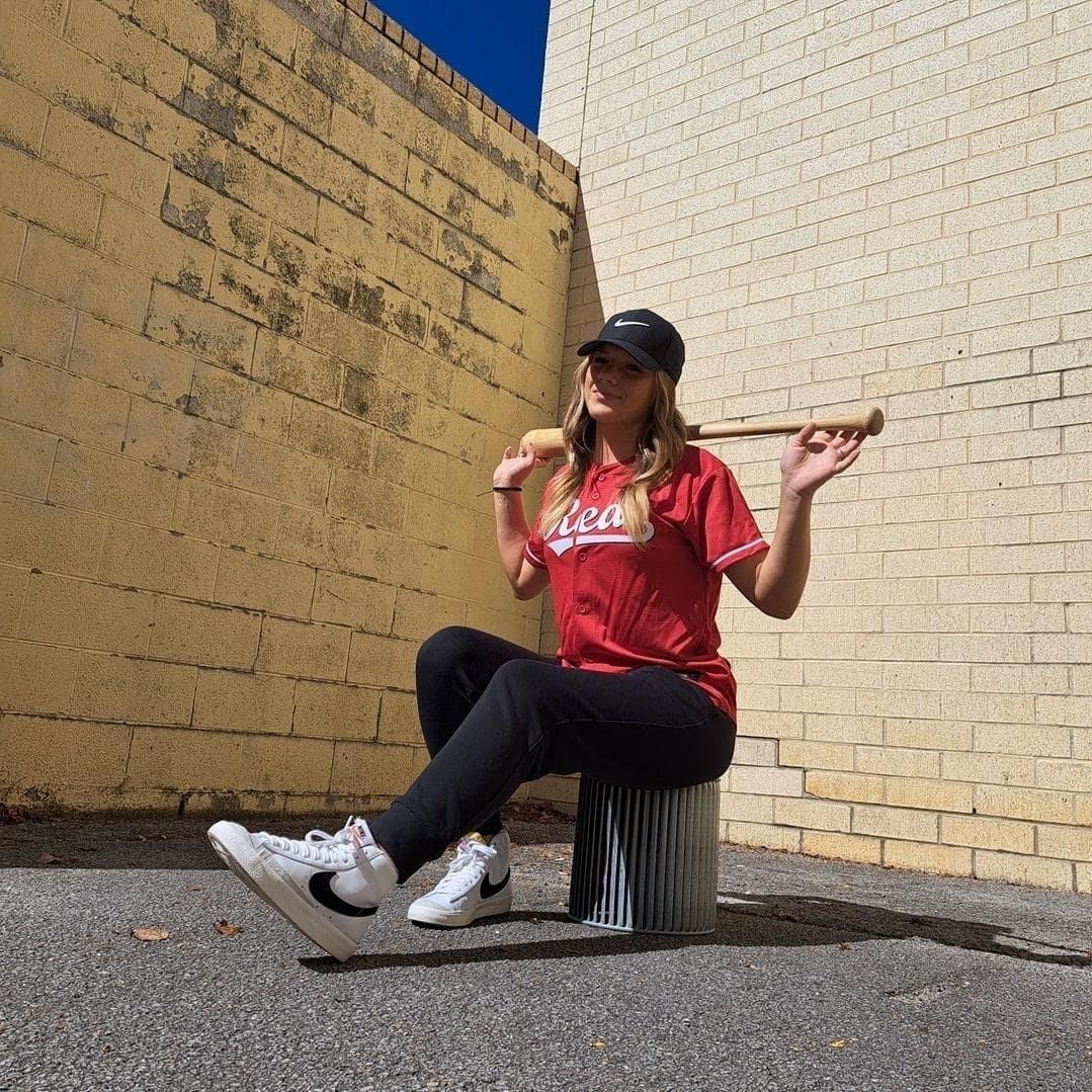 Girl in baseball jersey