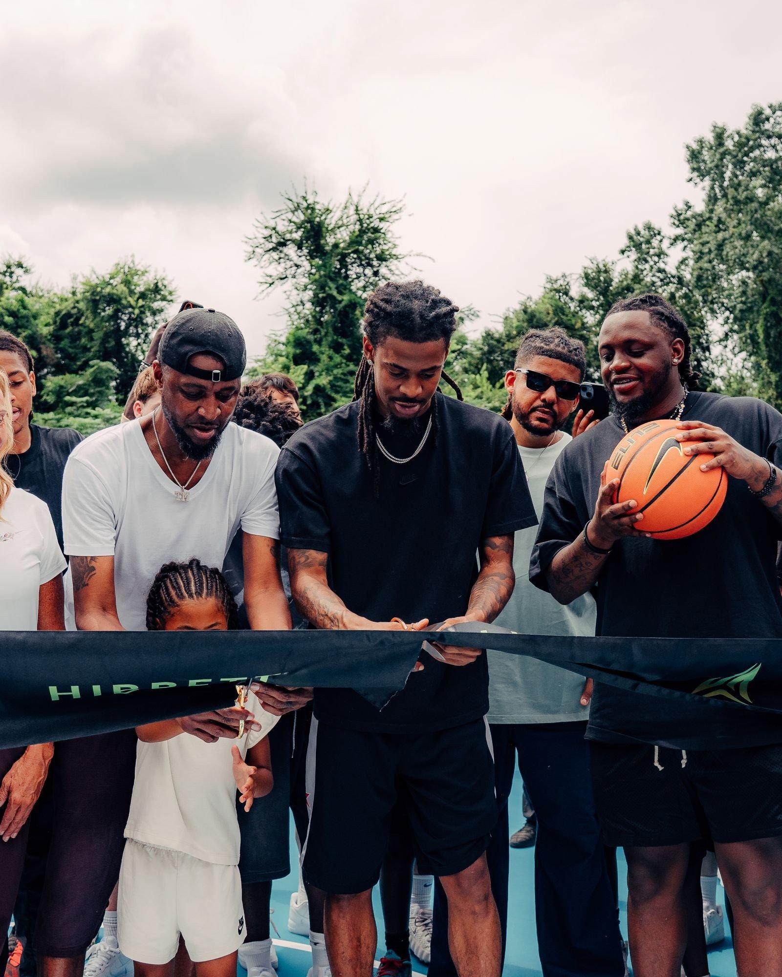 Participants cut the ribbon during the unveiling of a renovated community basketball court supported by Hibbett and Nike in Sumter, South Carolina.