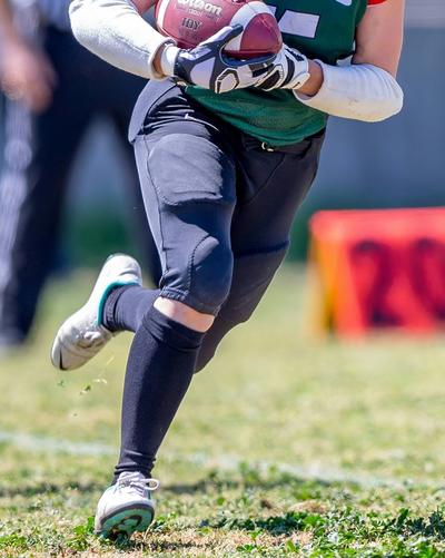 Football player running in cleats
