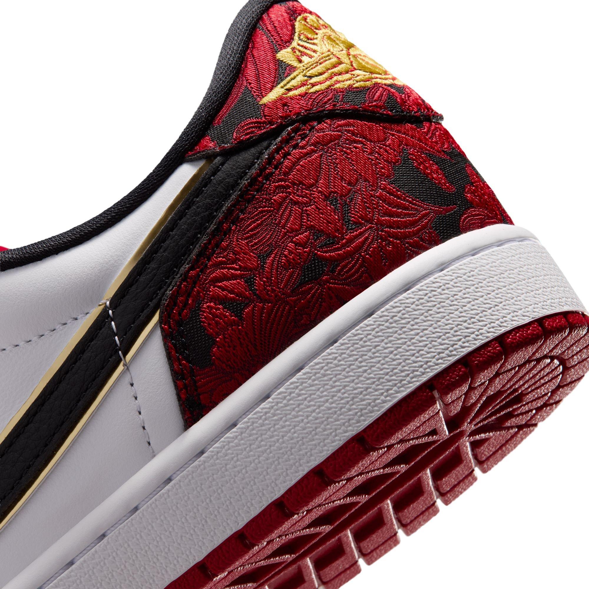 Close-up of the Air Jordan 1 Retro Low OG Garden heel featuring red-and-black floral fabric, a gold Wings logo and a red outsole.