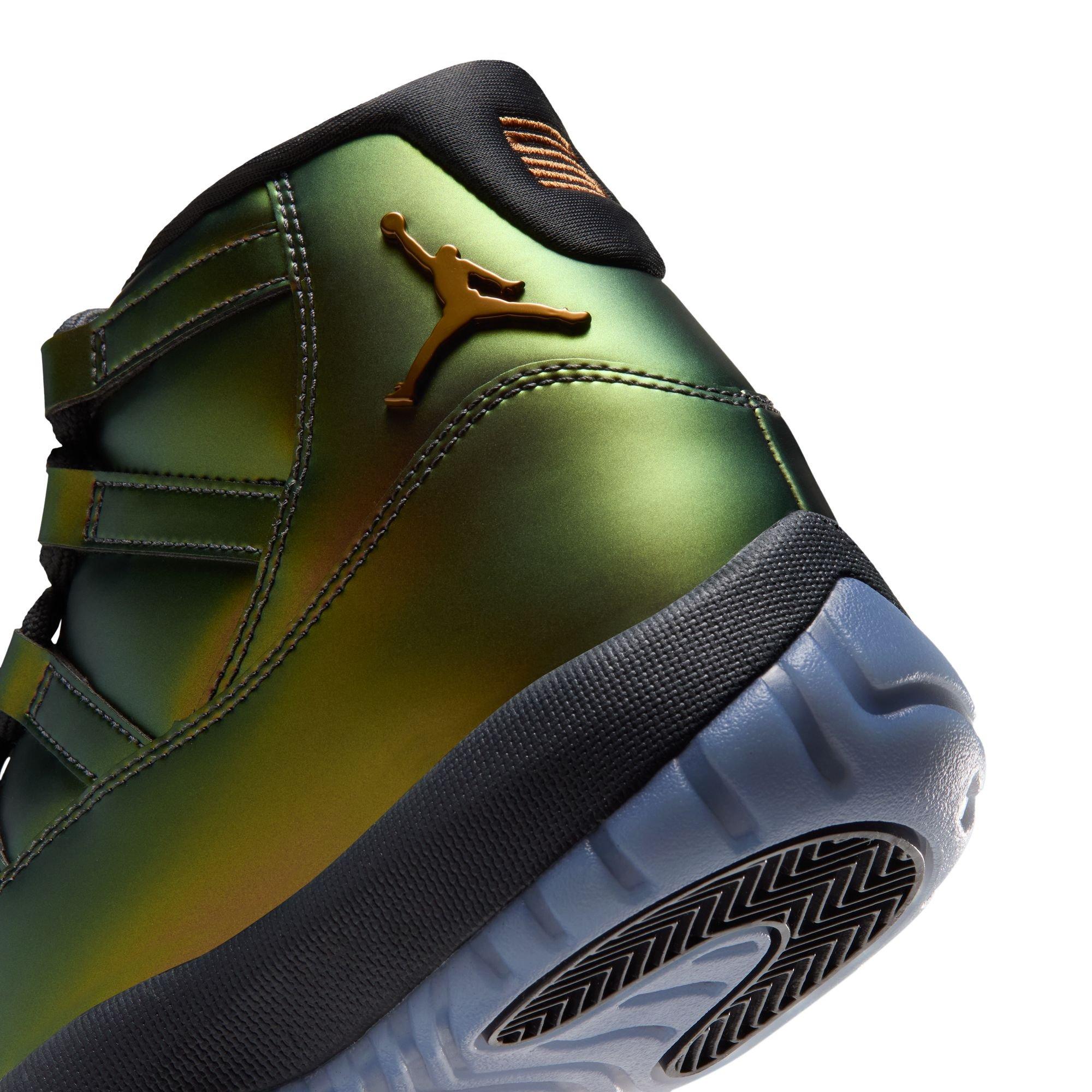 Close-up of a metallic green Jordan sneaker featuring a bronze Jumpman logo, black collar and translucent blue outsole.
