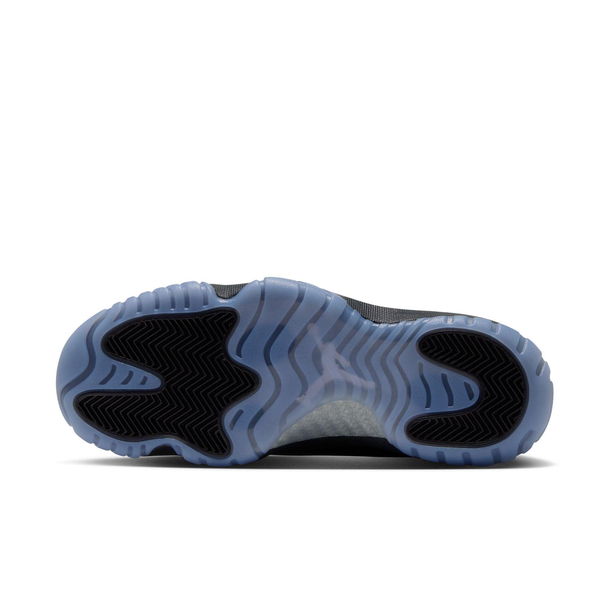 Bottom view of a Jordan sneaker showing a translucent blue outsole with black herringbone traction panels and a carbon-fiber midfoot section.