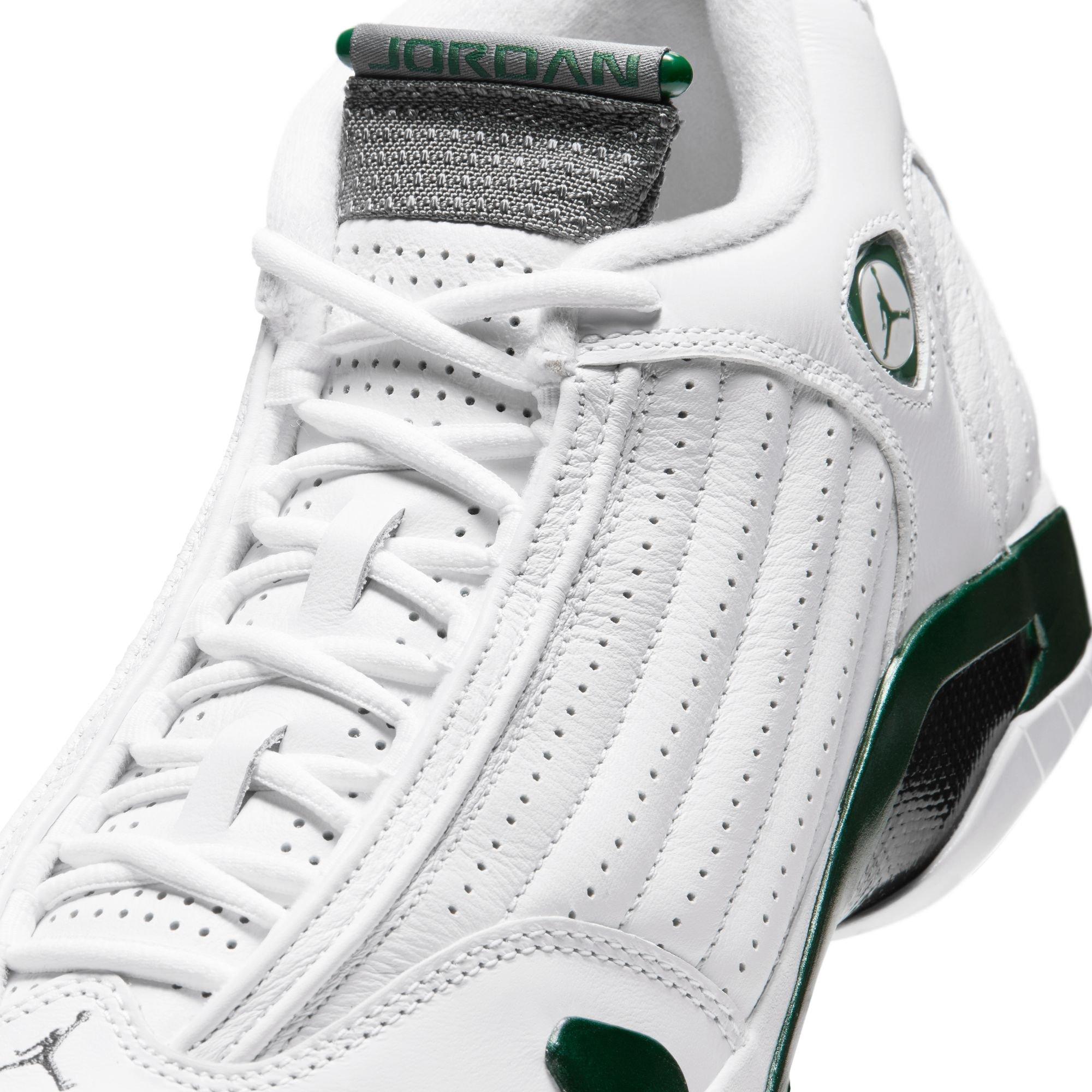 Close-up of the Jordan 14 Retro Forest Green sneaker featuring white laces, perforated white leather, a gray tongue with green Jordan branding and metallic green accents.